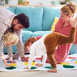 A family playing twister on a rainy day