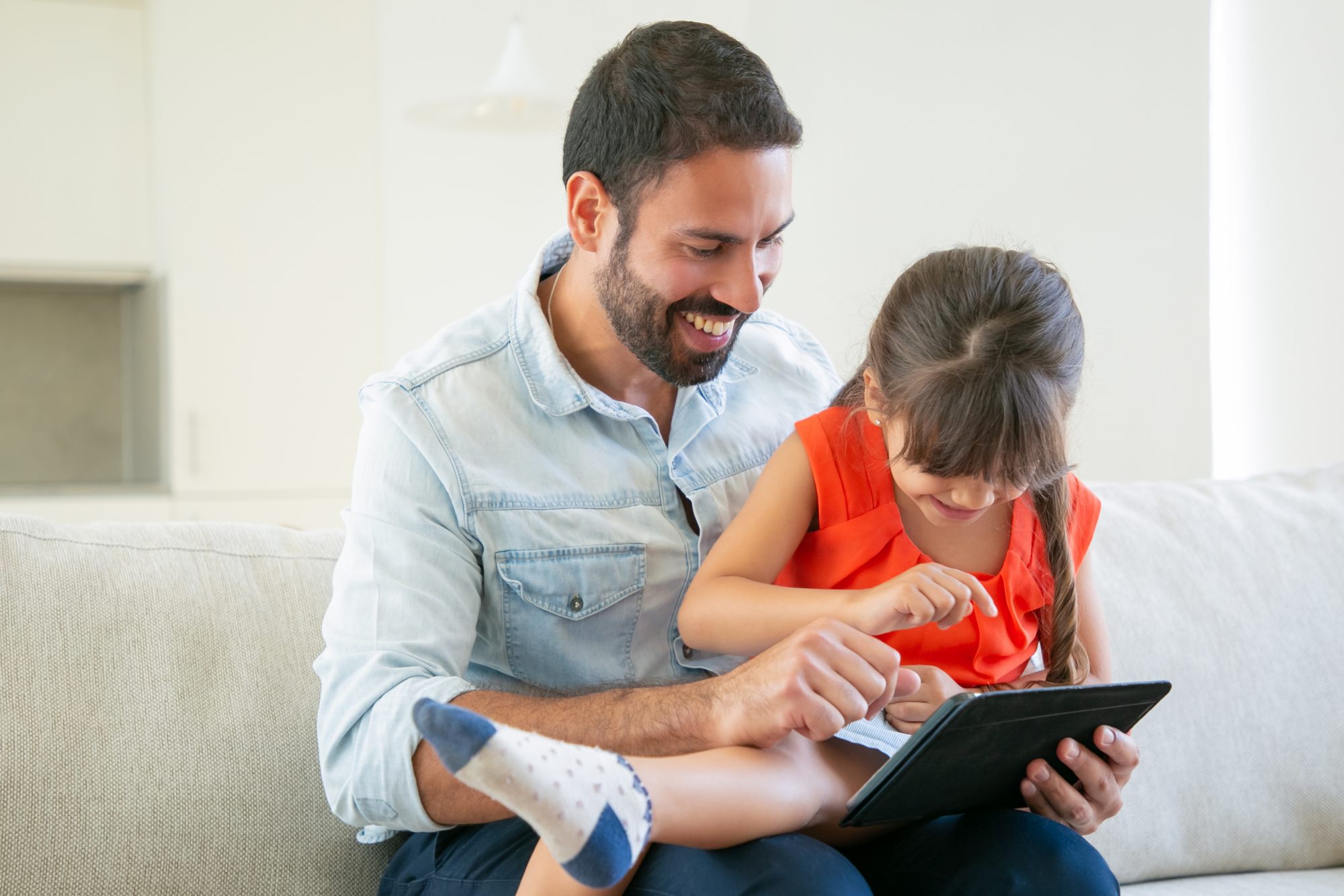 A child enjoys a learning app for kids on a tablet