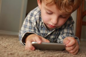 Boy playing games on a mobile phone